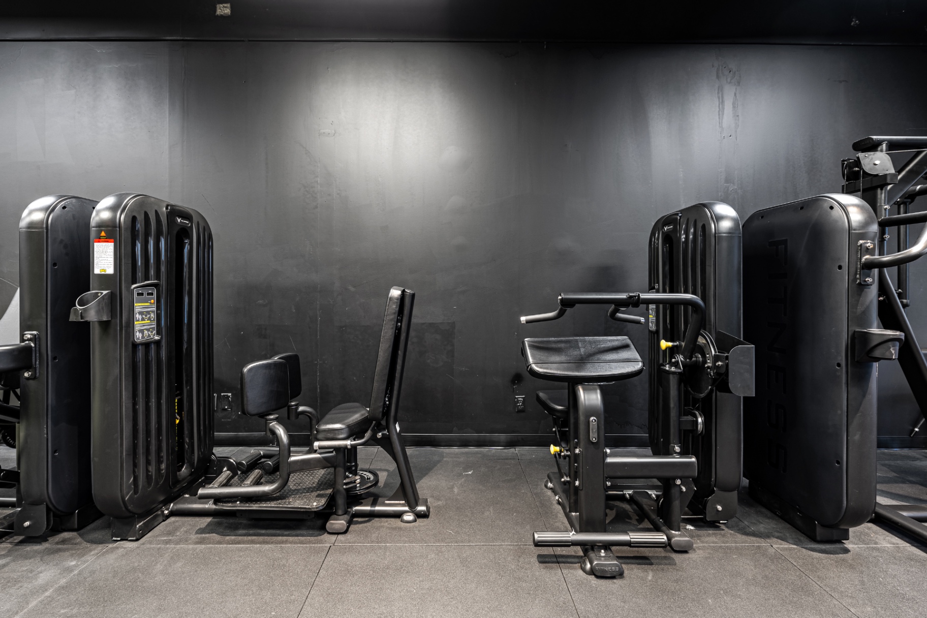 Selectorized strength machines on a charcoal floor at Elk Fitness